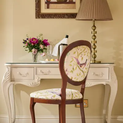 French-style dressing table set features a cream-colored console desk with delicate floral upholstery on the chair