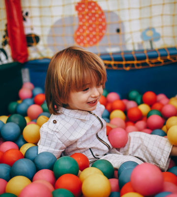 Child enjoys ball pit at The Little Riners Club at The Rine Hotel