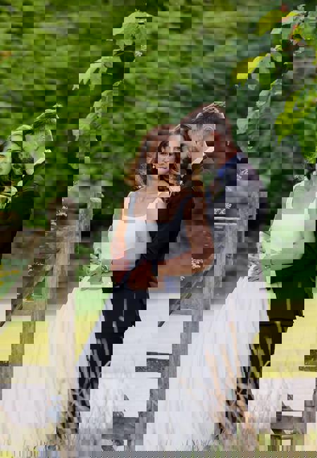 Newleywed couple pose next to fence in paddock at The Rine Hotel Estate in County Clare